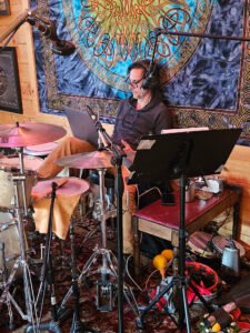 Pat of Fascination 127 listening to song playback during a recording session in Austin, Texas